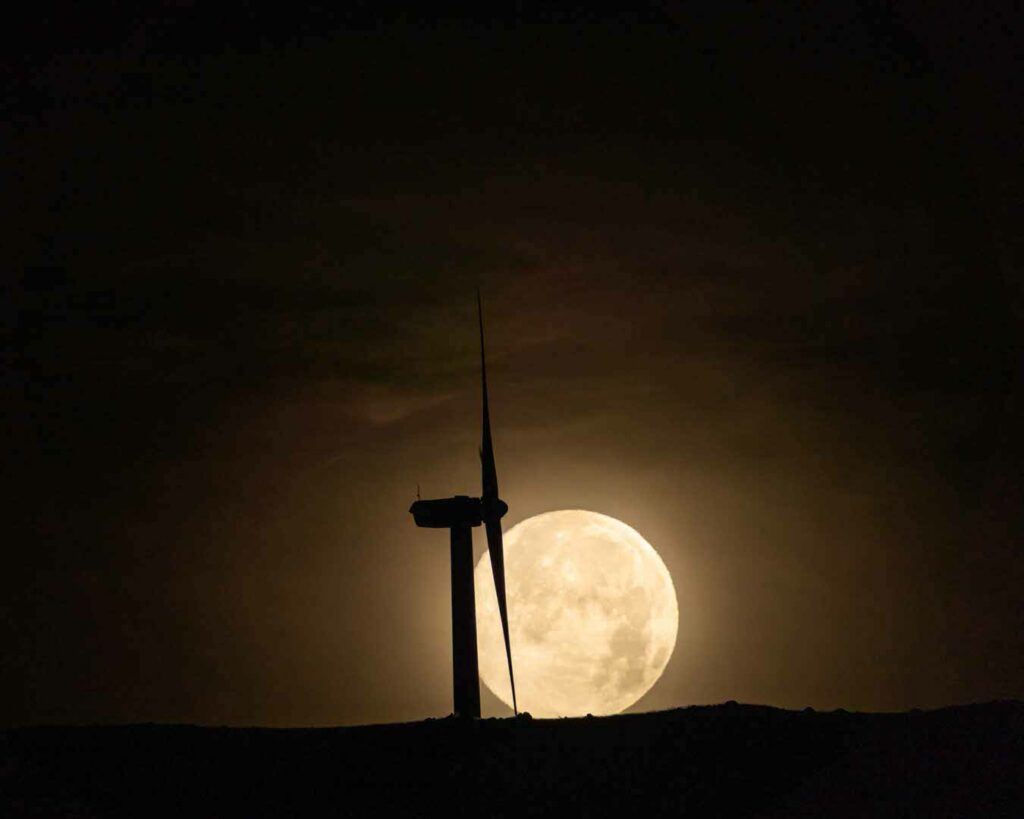 Wind turbine in the light of a full moon on Maui