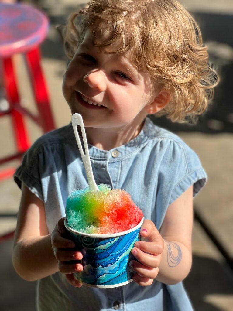 Happy girl with Hawaiian shave ice