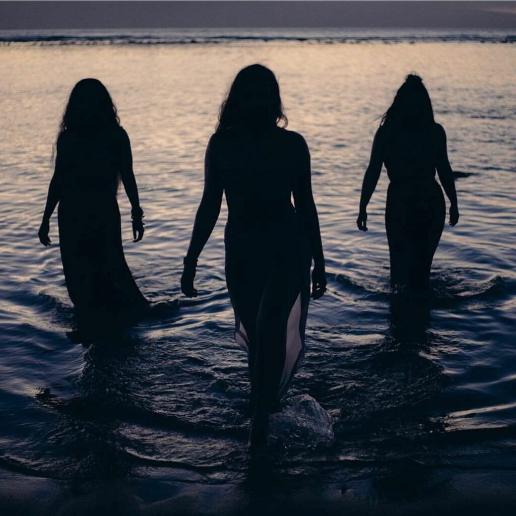Women in water in silhouette